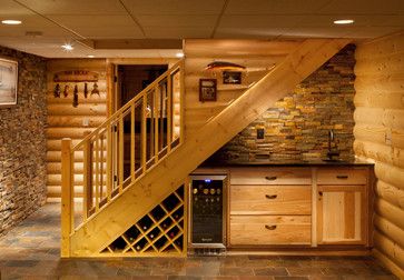 a wine cellar under the stairs in a log cabin