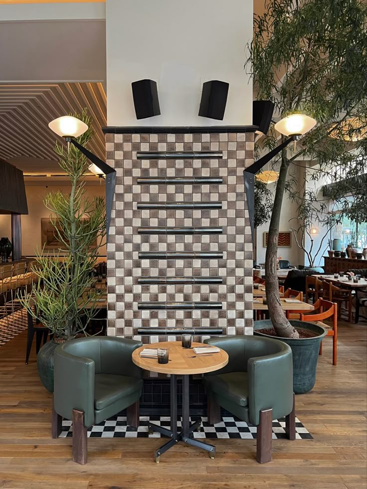 two green chairs sitting next to each other on top of a hard wood floored floor