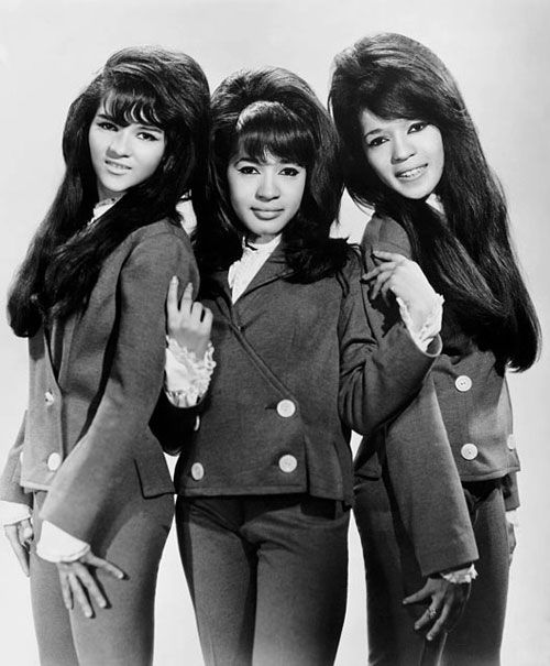 three young women standing next to each other