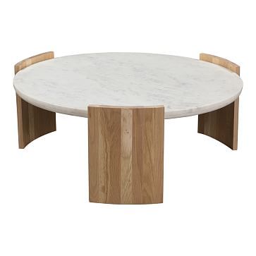 an oval marble table with wooden legs