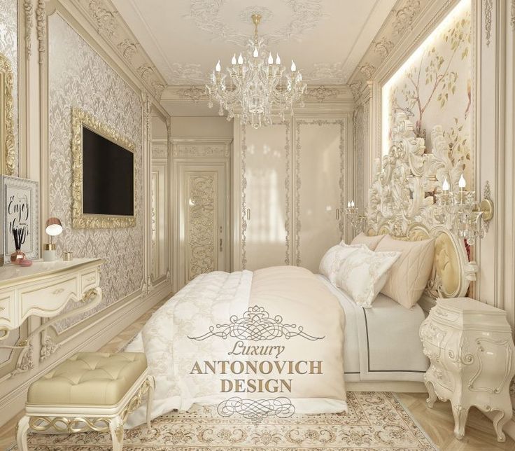 an elegant bedroom with chandelier, bed and dresser in white colors is shown