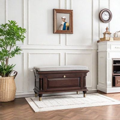 a living room with white walls and wood flooring, a painting on the wall