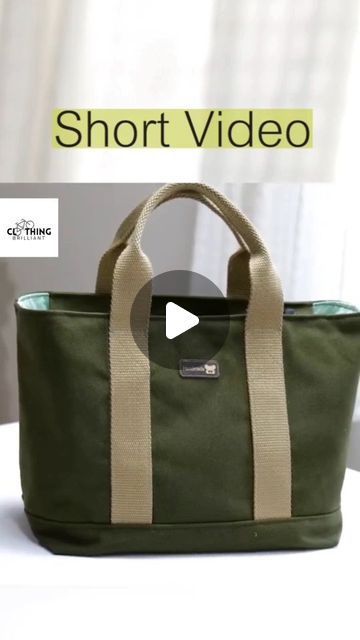 a green bag sitting on top of a table next to a white wall with the words short video