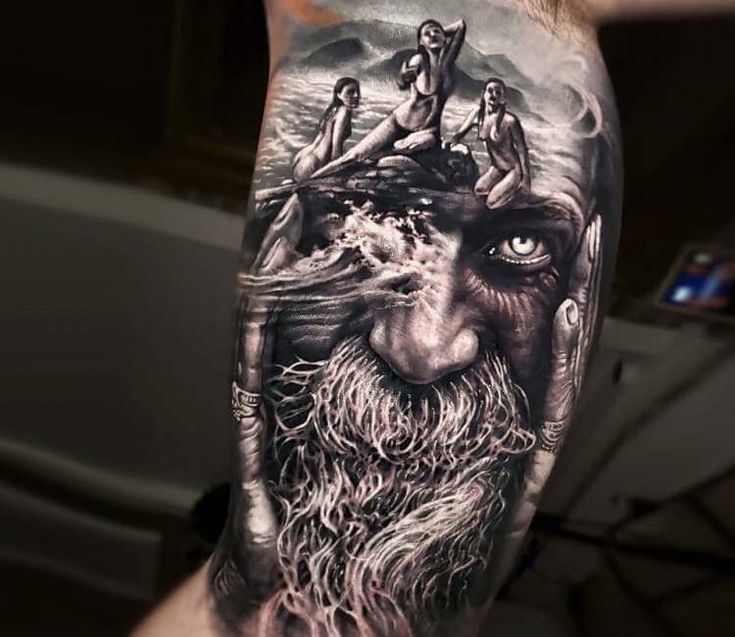 a man's arm with an image of a bearded face and people on it