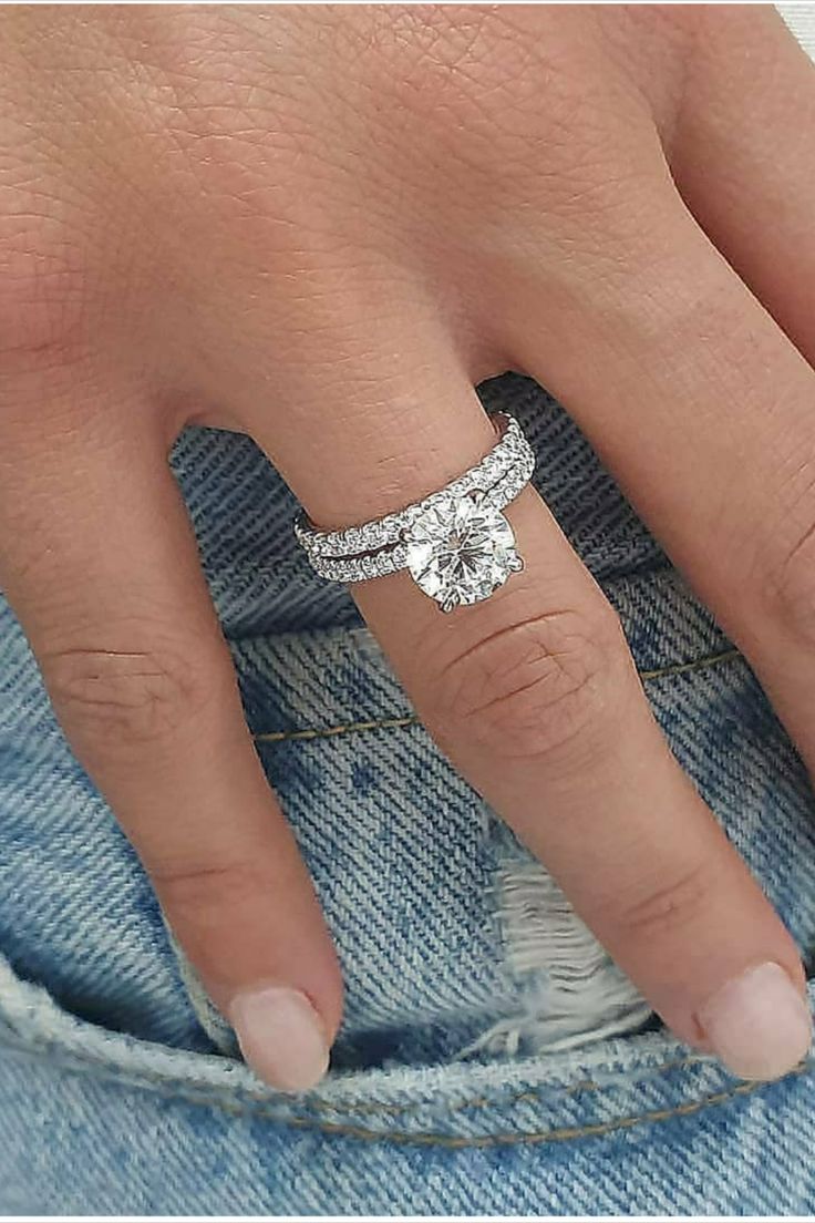 a woman's hand with a diamond ring on her finger and the bottom half of her left hand