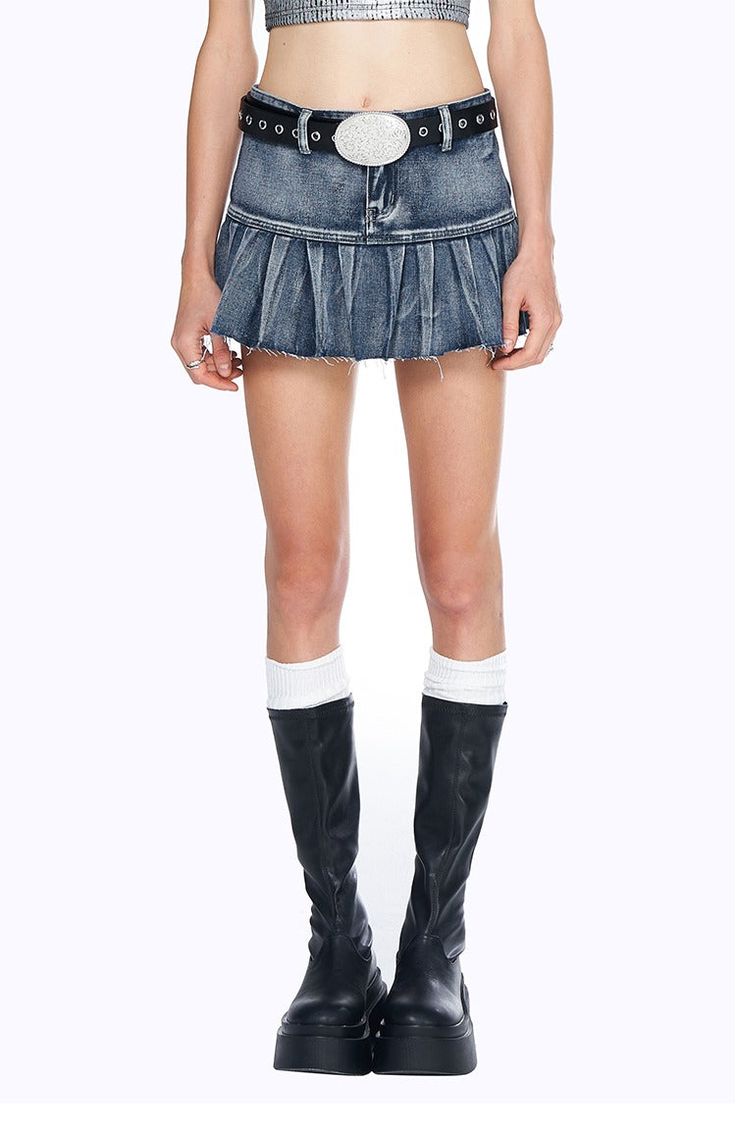 Capture y2k vibes with this classic denim pleated mini skirt. Perfectly ruffled and featuring raw edges, this cotton poly blend is sure to become your go-to item. Style it up or keep it simple. Model is 5'6 108lbs wearing S Edgy Denim Mini Skort, Spring Y2k Mini Skirt With Frayed Hem, Y2k Style Mini Skirt With Frayed Hem For Spring, Y2k Mini Skirt With Frayed Hem, Y2k Style Cotton Cutoff Mini Skirt, Edgy Cotton Cutoff Mini Skirt, Edgy Cutoff Cotton Mini Skirt, Edgy Fitted Denim Skirt With Frayed Hem, Y2k Style Medium Wash Cotton Mini Skirt