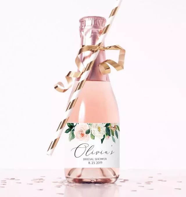 a bottle of wine with a gold ribbon on the top and label that says, glamas