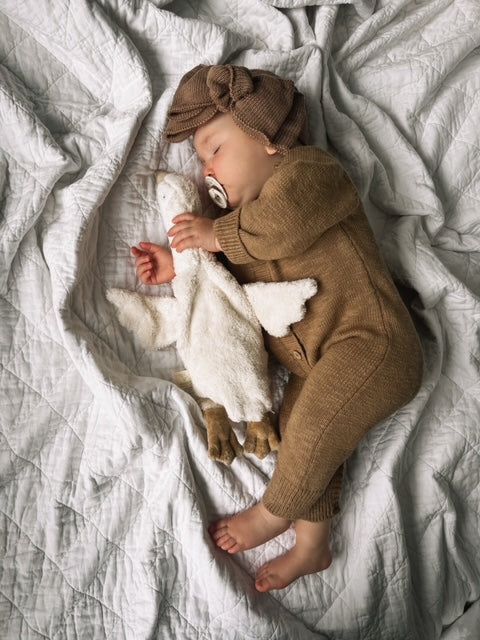 Meet the perfect blend of style and practicality with our luxe knitted romper, crafted to keep your little one comfy and cute! Made from 100% soft cotton, this romper makes it a delightful choice for all-day wear. Features: The Luxe Romper is accented with charming wooden buttons along the body, this romper adds a touch of rustic charm to your baby’s wardrobe. The button snaps at the bottom ensure that diaper changes are a breeze, allowing you to focus on all the fun moments in between! Available in a selection of neutral colors, it’s easy to mix and match with your baby’s favorite accessories. Mix and match with our matching luxe accessories including our beanie, booties or topknot. SIZING *We recommend sizing up, as this romper tends to run small. If your child is between sizes, we highl Knit Bow, Family Outings, Knit Headband, Toddler Bows, Knitted Romper, Family Outing, Wooden Buttons, Stylish Kids