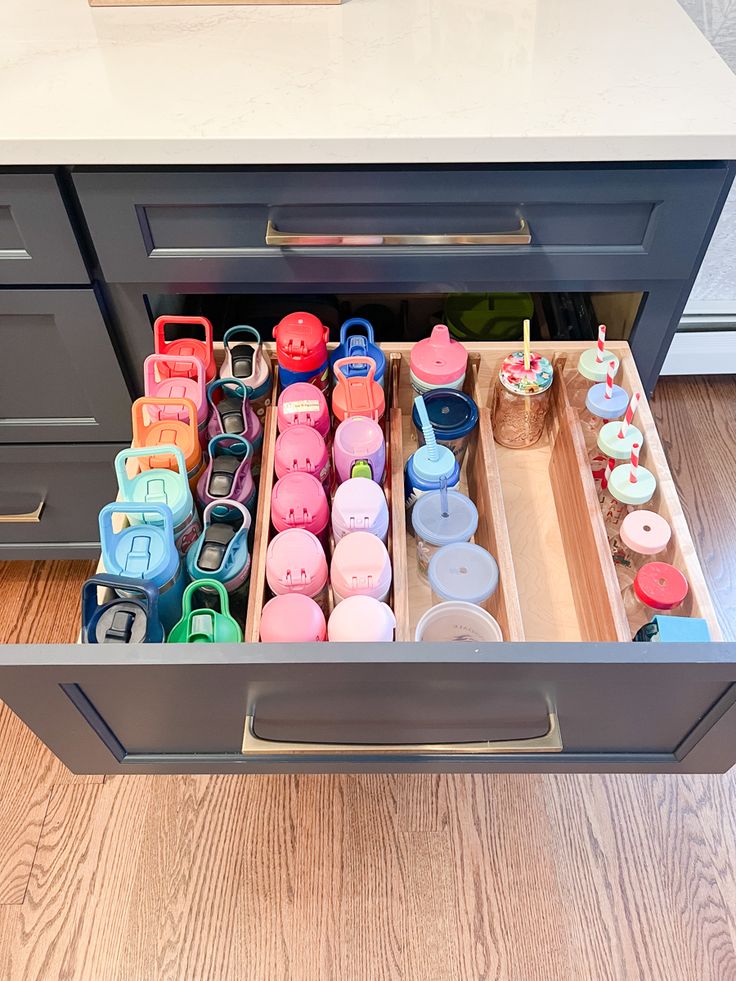 Kids drawer bottles water dividers acacia wood kitchen home Drink Bottle Organization, Kitchen Storage Water Bottles, Water Bottle Drawer Storage, Kids Cups Organization, Dream Kitchen Organization, Pantry Water Bottle Storage, Kids Kitchen Drawer Organization, Drink Bottle Storage, Cup Drawer Organization