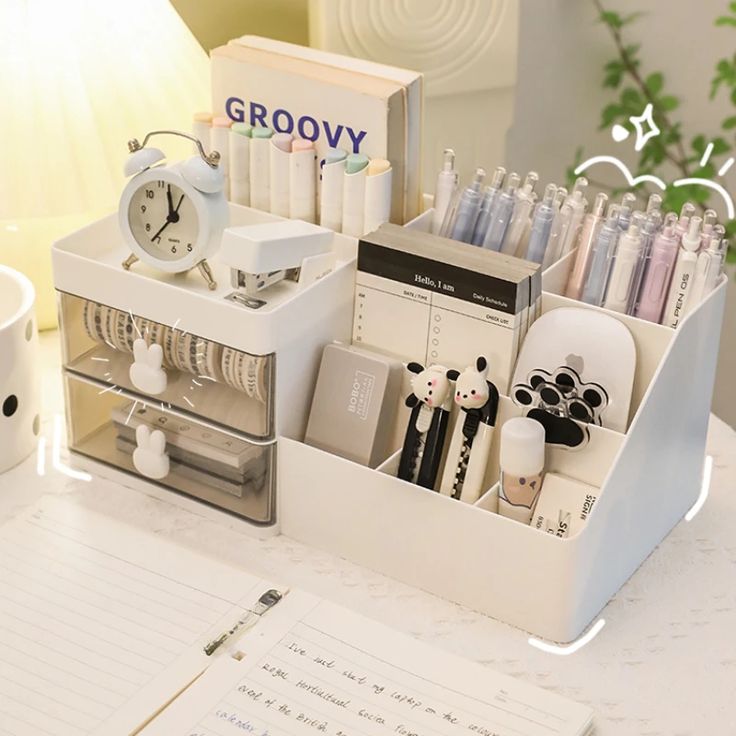 an organized desk with pens, pencils and other office supplies on top of it