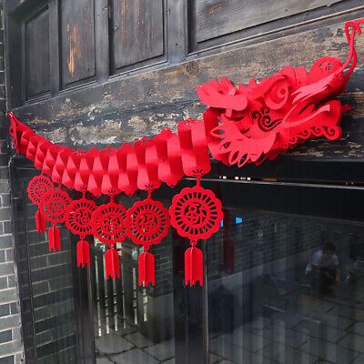 a red dragon decoration hanging from the side of a building