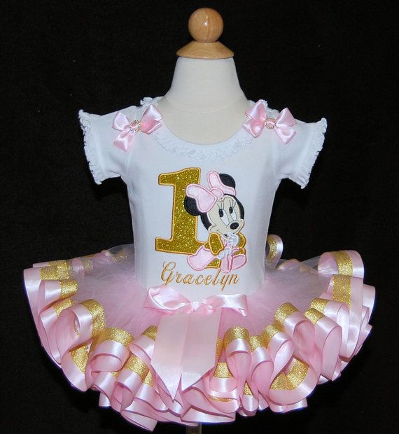 a pink and gold minnie mouse 1st birthday tutu skirted outfit with the number one on it