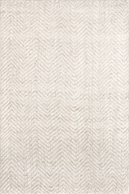 a white rug with an arrow pattern on the top and bottom, in front of a gray background