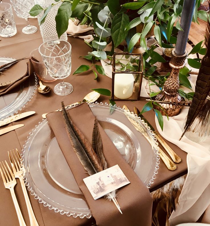 the table is set with place settings, silverware, and napkins for an elegant dinner