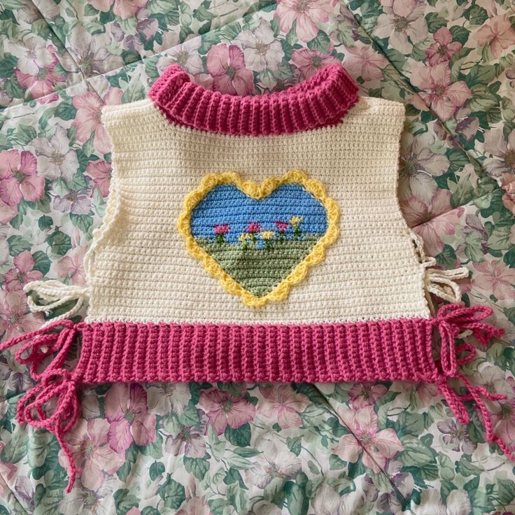 a crocheted sweater with a heart on it