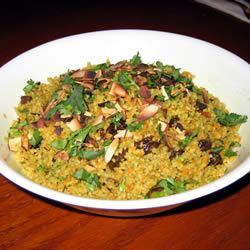 a white bowl filled with food on top of a wooden table