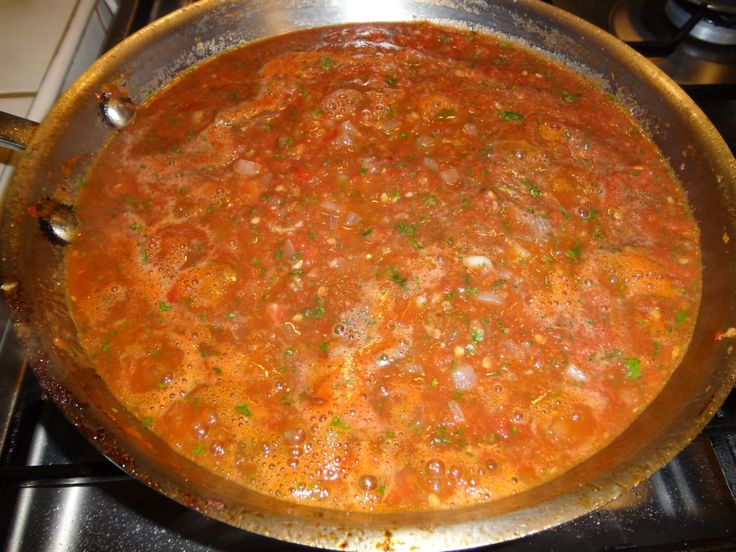 a pot filled with soup sitting on top of a stove