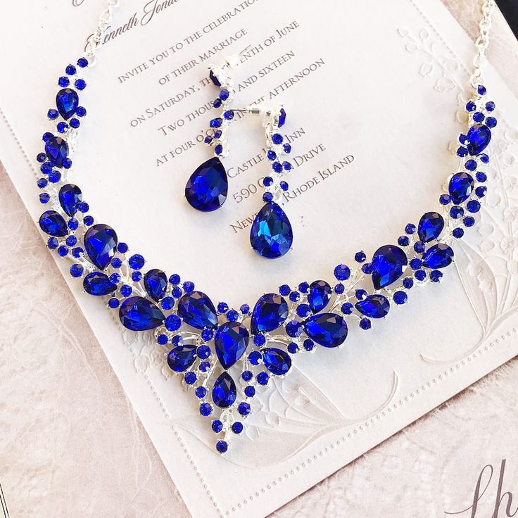 a blue necklace and earring set with matching earrings