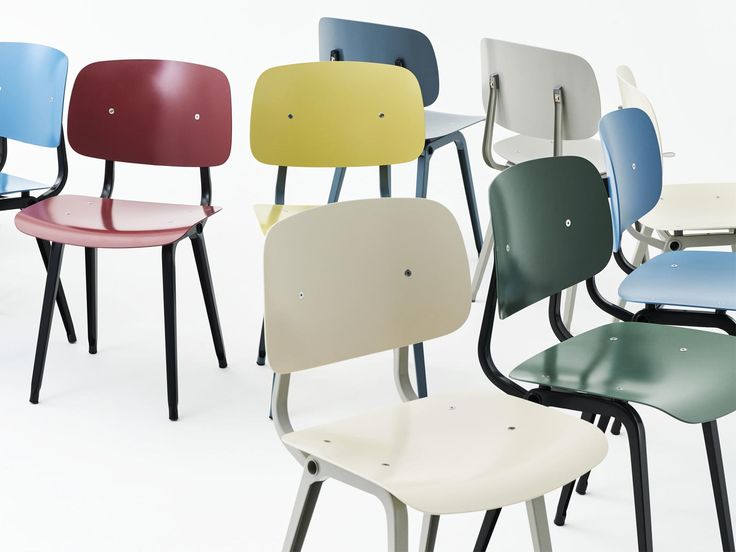 six chairs with different colors and shapes in the same row, all facing one another