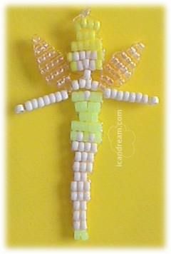 an ornament made out of beads on a yellow background