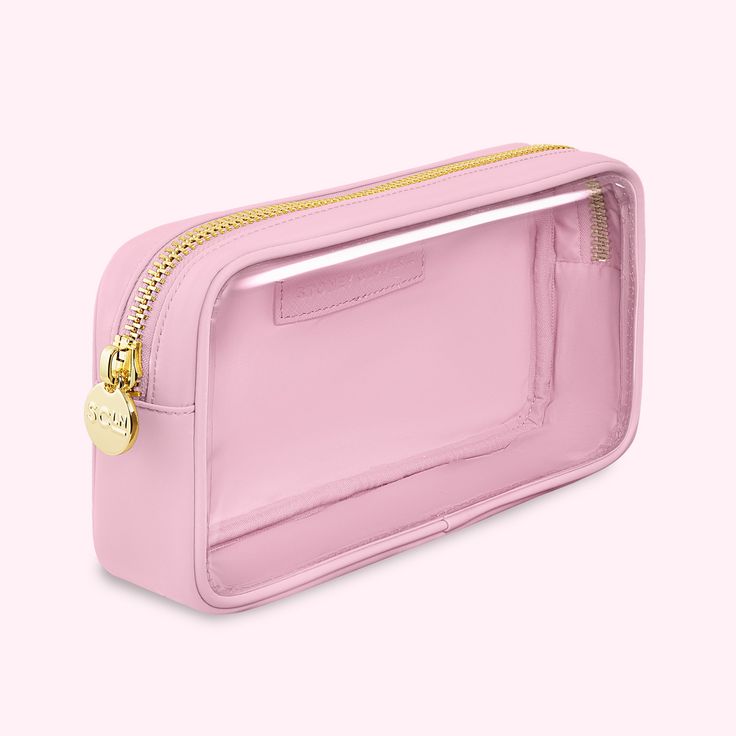 a pink purse with gold hardware on the front and side zippers that are open