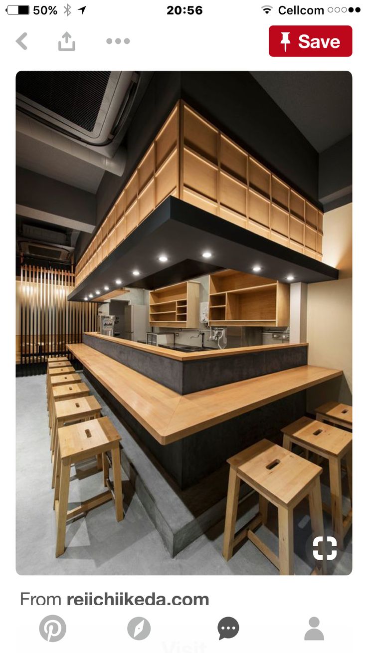 an image of a restaurant with wooden tables and stools in the middle of it