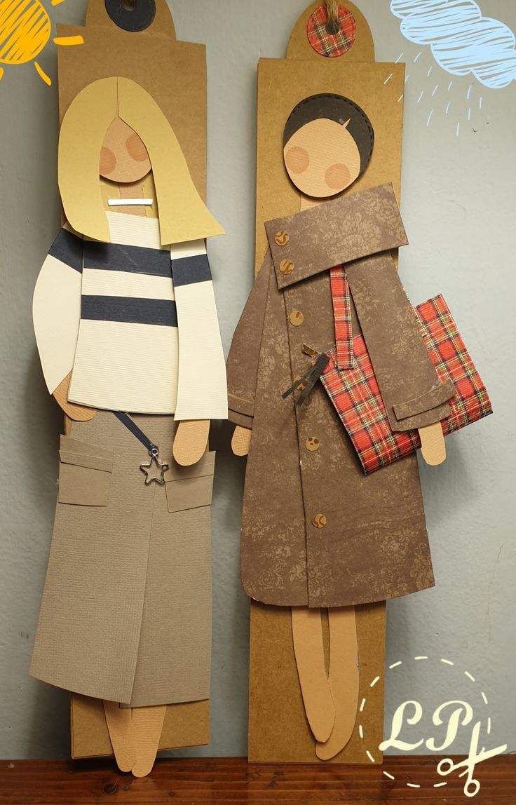 two paper dolls are standing next to each other