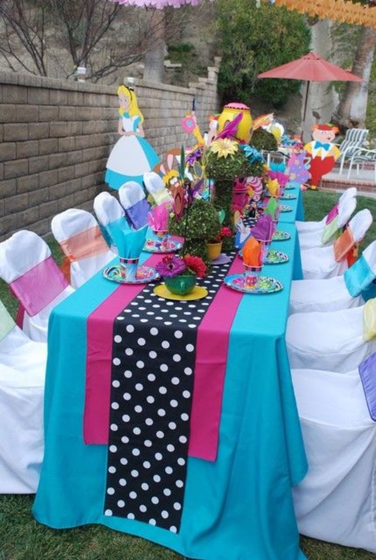 the table is decorated with polka dots and colorful napkins on it's runners