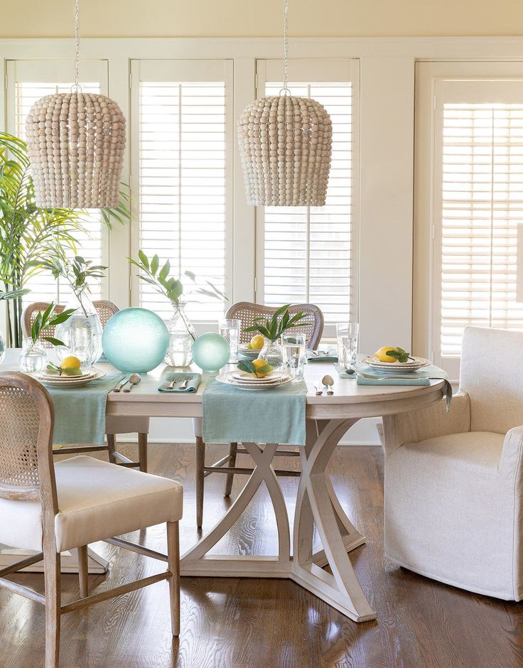 a dining room table with chairs and plates on it