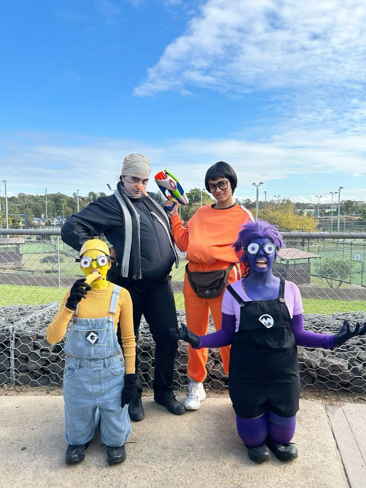 three adults and two children dressed up as characters from the simpsons are posing for a photo