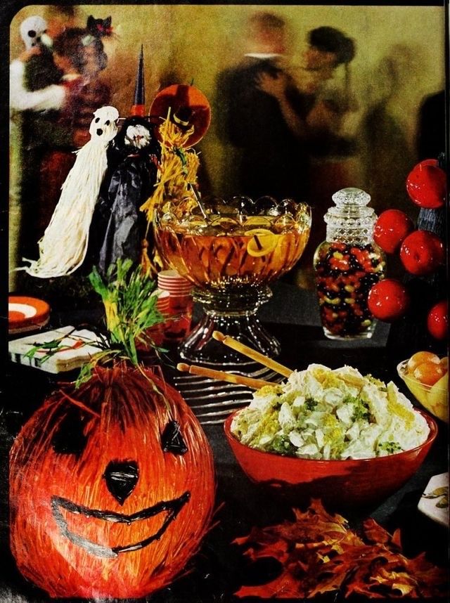 a table topped with lots of halloween food