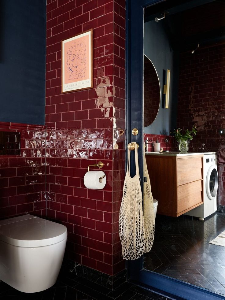 a bathroom with red brick walls and white toilet