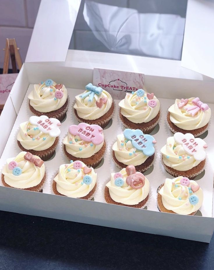 a box filled with lots of cupcakes covered in frosting