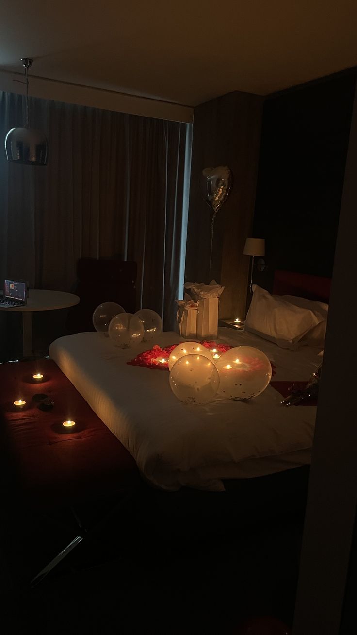 candles are lit on a bed in a dimly lit room