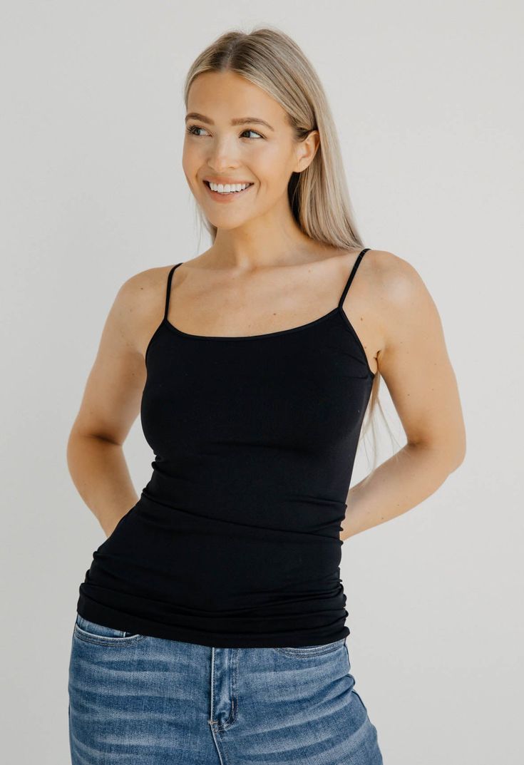 Style & Details: Signature Camisole Form Fitting Spandex Material - Stretchy Best Seller Great For Layering Sizing & Fit: Model is wearing one sizeModel Height: 5’8Waist: 26inHips: 34inBust: 34inBased on one size Fabric & Care: 92% Nylon8% SpandexHand Wash ColdHang or Lay Flat to DryITEM#: NS4011 Shipping: Free Shipping when you spend $100 or more!Orders below $100 will be charged $7 for standard shippingOrders typically ship within 1-3 business daysWe will gladly accept returns on items that ar Black Cami Top With Built-in Bra, Black Stretch Camisole With Spaghetti Straps, Black Seamless Camisole With Spaghetti Straps, Black Seamless Spaghetti Strap Camisole, Black Spaghetti Straps Top For Layering, Everyday Black Tank Top With Adjustable Straps, Stretch Camisole With Built-in Bra For Layering, Black Camisole With Built-in Bra For Layering, Black Tank Top With Built-in Bra And Spaghetti Straps