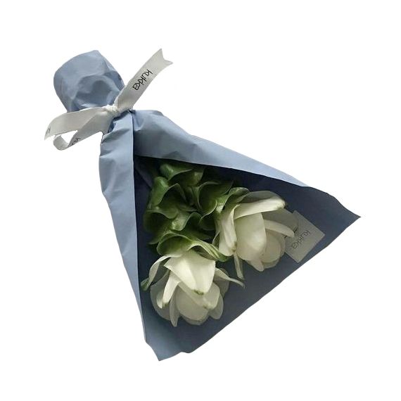 a bouquet of white tulips wrapped in a blue paper with a ribbon tied around it