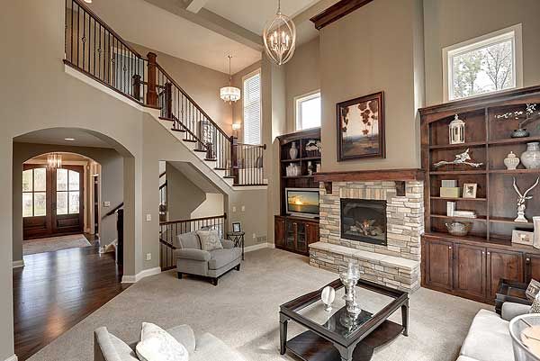 a living room filled with furniture and a fire place in the middle of a room