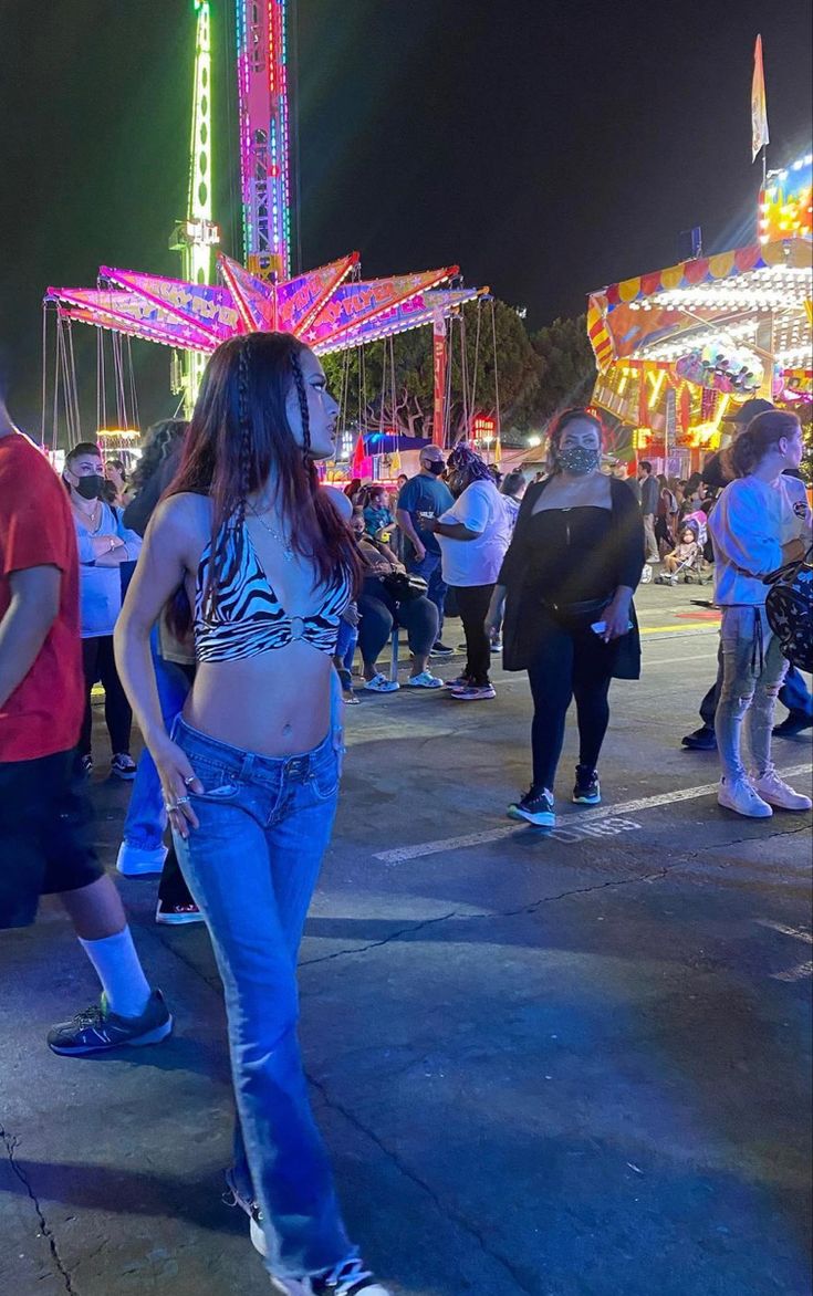 a group of people standing around at an amusement park