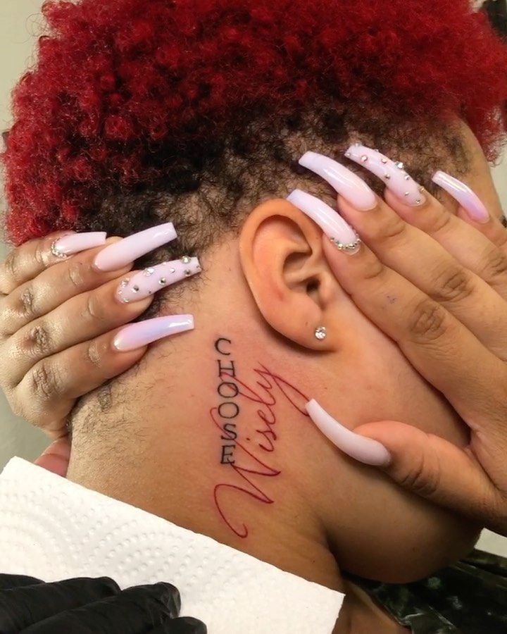 a woman with red hair and white nails has her head covered by fake nails that spell out the word love