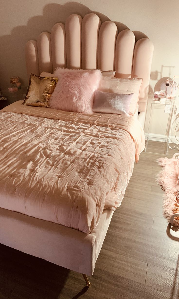 a bed with pink pillows on top of it