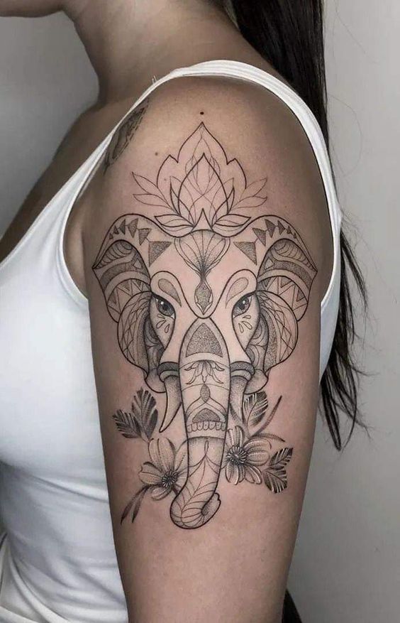 an elephant with flowers and leaves on it's shoulder is shown in black ink