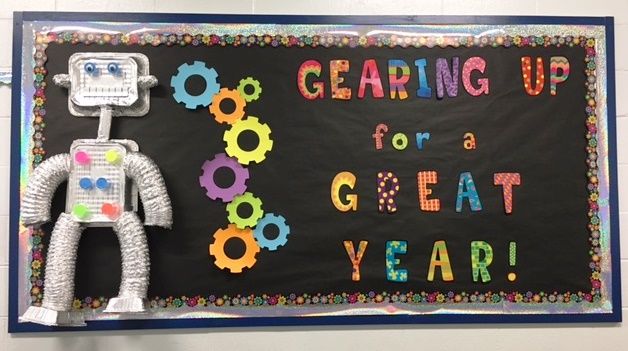 a bulletin board with an image of a robot and the words gearing up for a great year