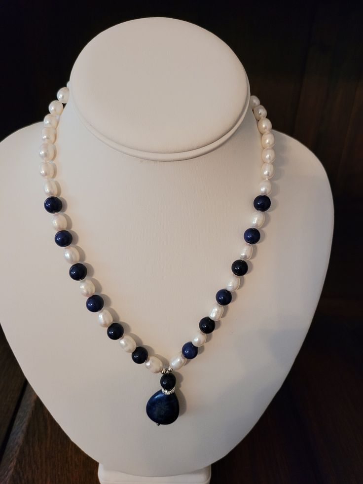 The necklace has 8mm created lapis stones and 9mm freshwater pearls for the strand and a 10 carat pear cut lapis stone. Elegant Beaded Necklaces With Round Lapis Lazuli Beads, Elegant Lapis Lazuli Beaded Necklaces With Round Beads, Elegant Lapis Lazuli Beaded Necklace With Round Beads, Elegant Lapis Lazuli Beaded Necklaces, Elegant Lapis Lazuli Beaded Necklace, Elegant Lapis Lazuli Necklace With Polished Beads, Elegant Lapis Lazuli Gemstone Beaded Necklaces, Elegant Lapis Lazuli Gemstone Beaded Necklace, Elegant Single Strand Lapis Lazuli Beaded Necklaces