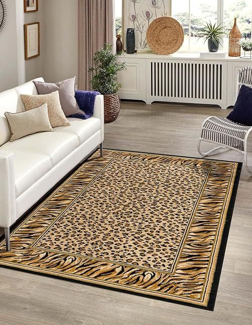 a living room with white couches and a leopard print area rug on the floor