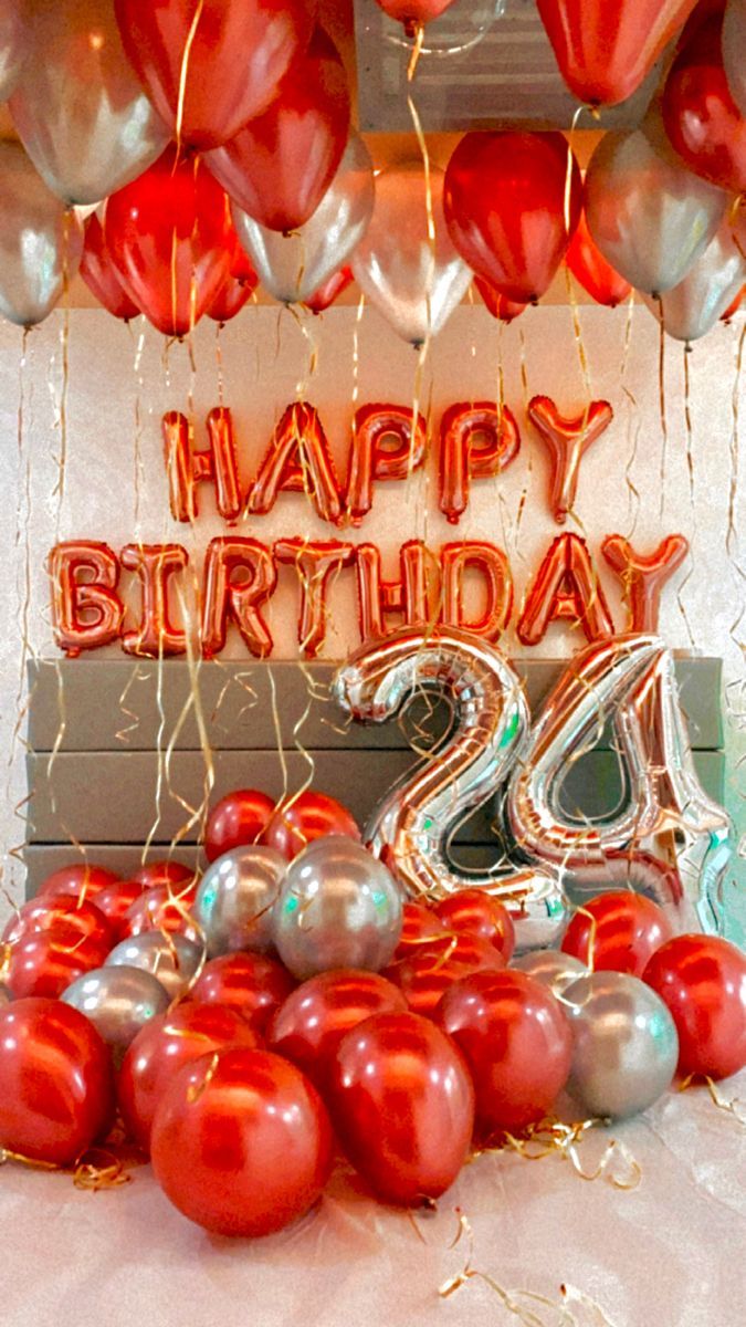 a birthday cake with balloons and the number twenty two surrounded by red and silver balloons