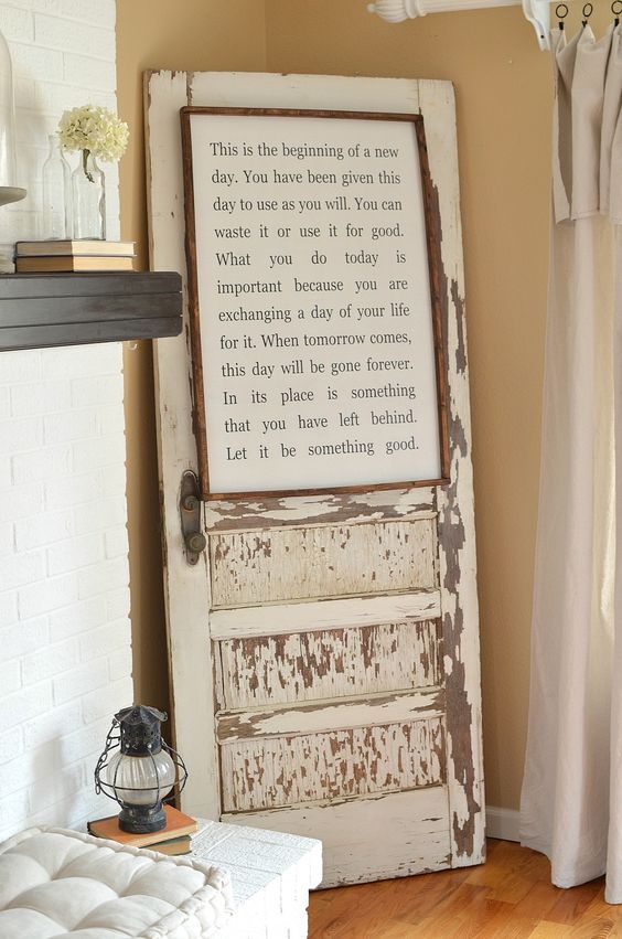 an old door with a poem written on it in front of a fireplace mantel