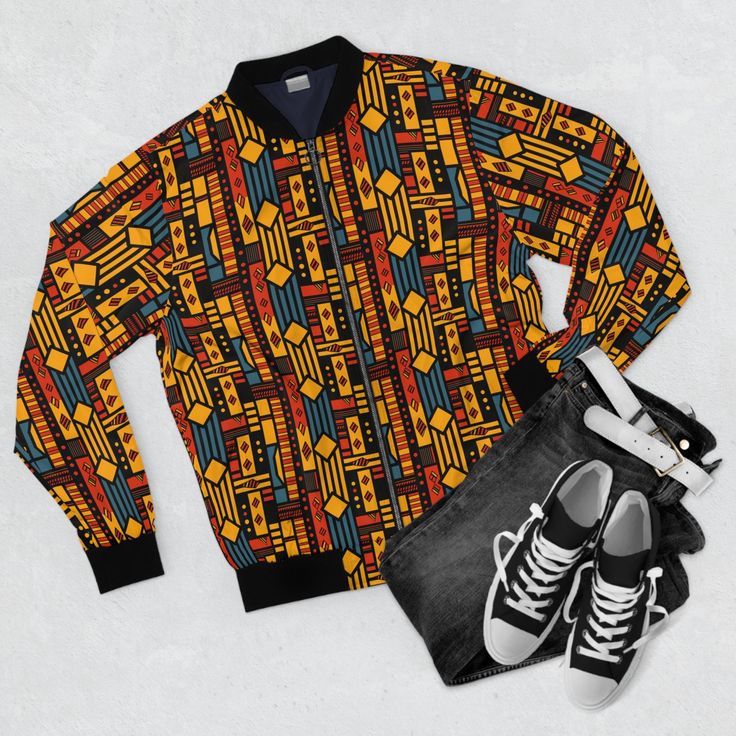 Step into a world of vibrant heritage and style with our Retro 1990's African Print Men's All-Over Bomber Jacket. This unique jacket blends the essence of traditional kente cloth with the classic 1990's aesthetic, creating a fashion statement that's truly one-of-a-kind. Featuring a ribbed stand-up collar, elastic cuffs, and an elasticized hem, this jacket embodies the iconic bomber jacket look. It's not just stylish but also practical with a durable metal zipper and two pouch pockets for your convenience. The dark blue polyester lining adds a touch of sophistication, making it a versatile piece for any occasion. Key Features: Material: 100% polyester Full front metal zipper closure Two lined welt pockets at the front Sewn-in label Elevate your everyday look with this unique jacket that ref Festival Jacket, Unique Jackets, Cozy Jacket, African Clothing For Men, Denim Jeans Men, Mens Fashion Fall, Stylish Jackets, Mens Fall, African Print