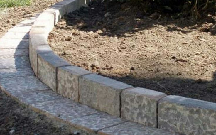 a brick walkway in the middle of a garden