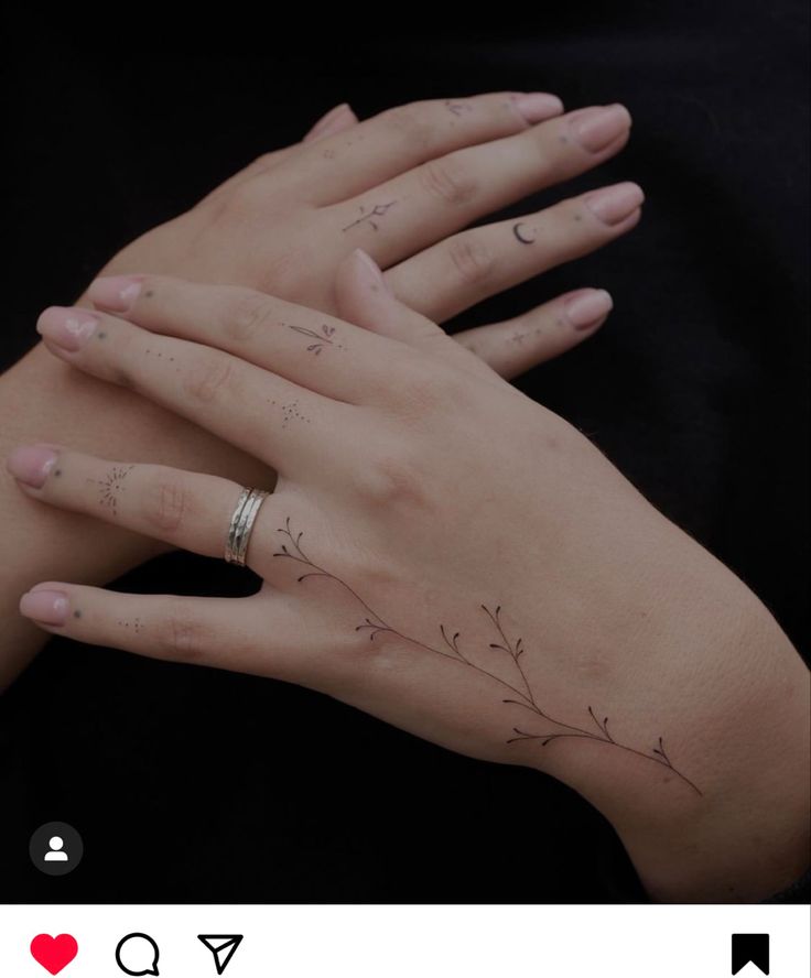 a woman's hands with tattoos on them