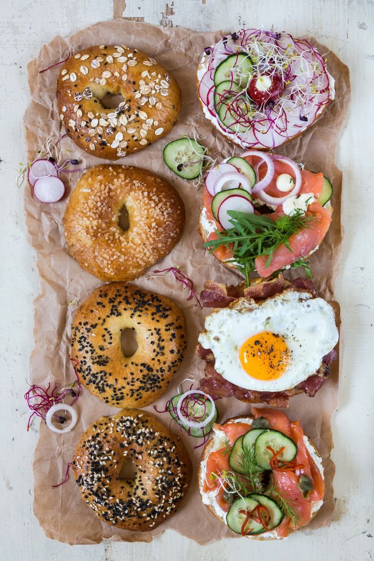 an assortment of bagels with different toppings on them